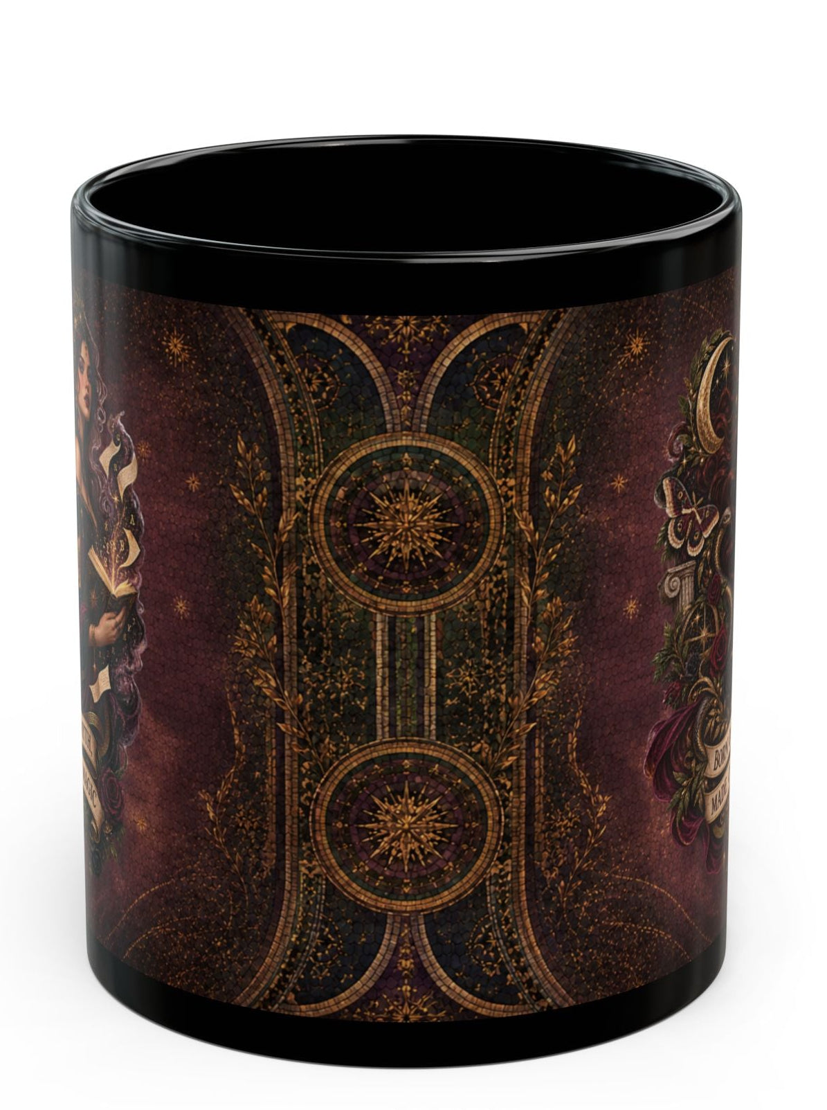 A black ceramic mug featuring an intricate, symmetrical celestial design in gold and deep burgundy tones, shown against a plain white background.