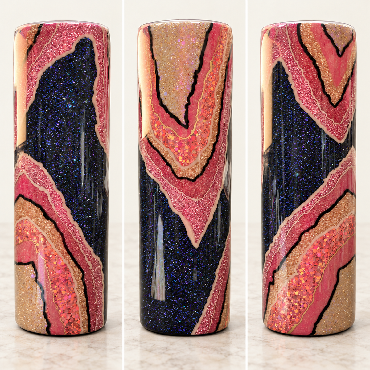 Three views of a cylindrical decorative vase featuring a glittery geode or agate pattern with navy blue, pink, and gold bands outlined in black, set against a light marble background.