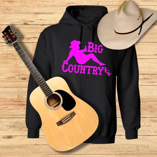 Black hoodie with 'Big Country ICT' text, acoustic guitar, and cowboy hat on a wooden surface