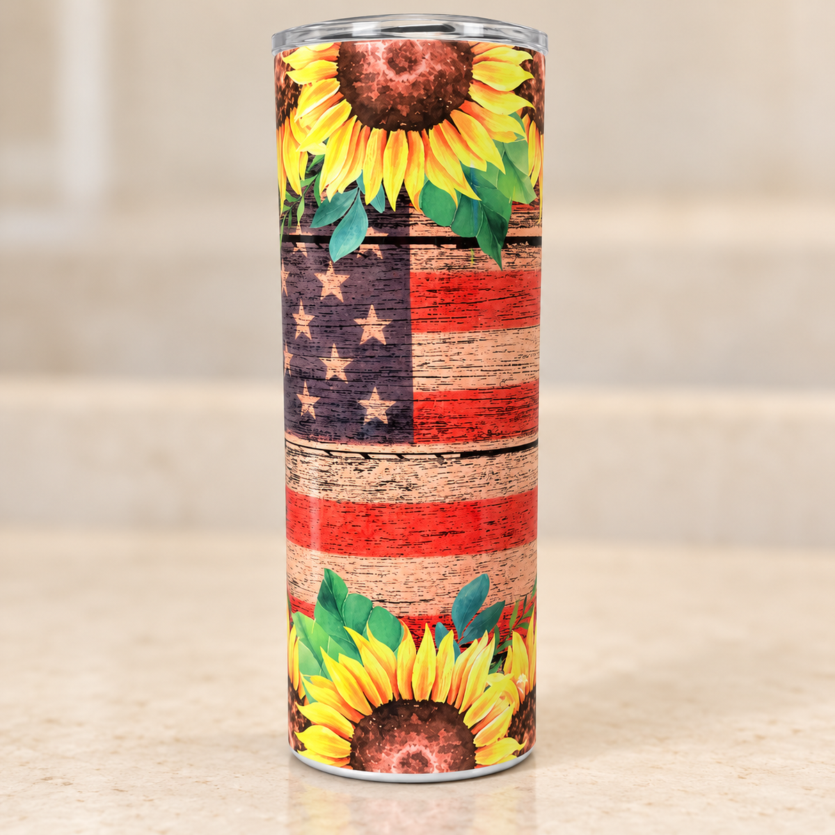 Stainless steel tumbler with yellow sunflowers, green leaves and a distressed wood-look American flag design.