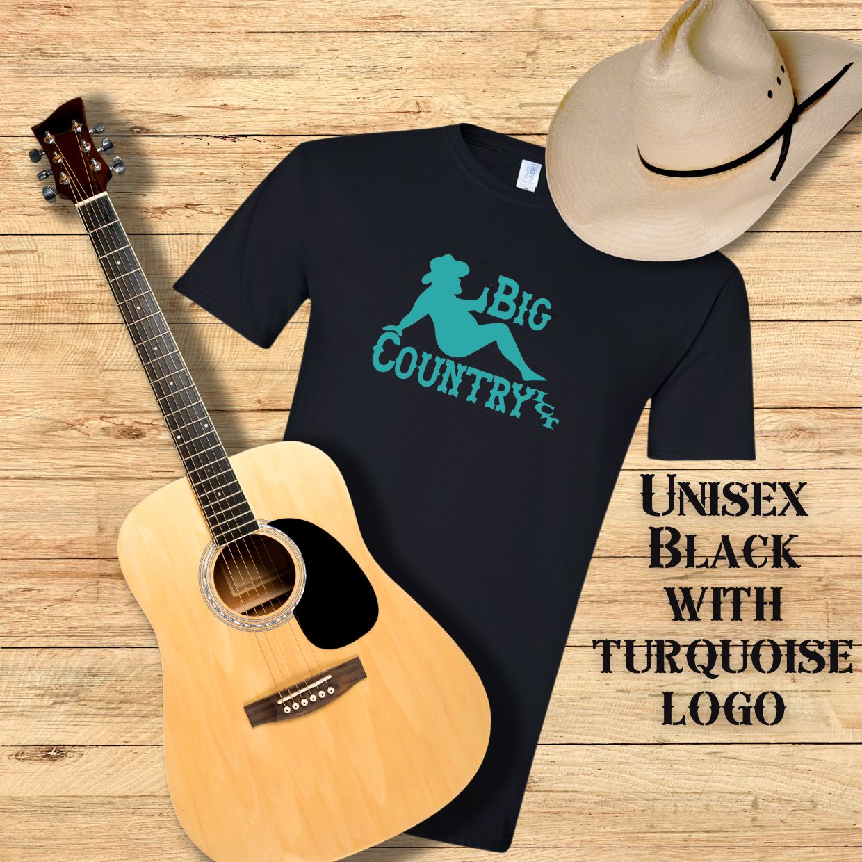 Black t-shirt with turquoise Big Country ICT logo, acoustic guitar, and cowboy hat on a wooden surface