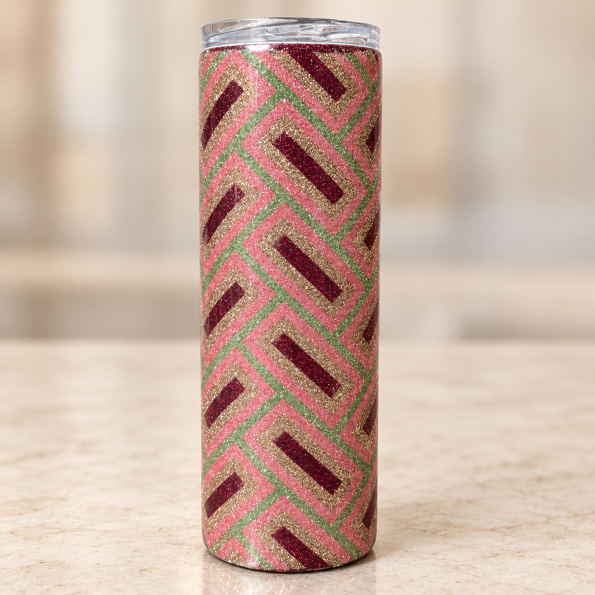 20 oz hand-glittered epoxy tumbler with a geometric pattern in sage green, gold, dusty rose and burgundy.